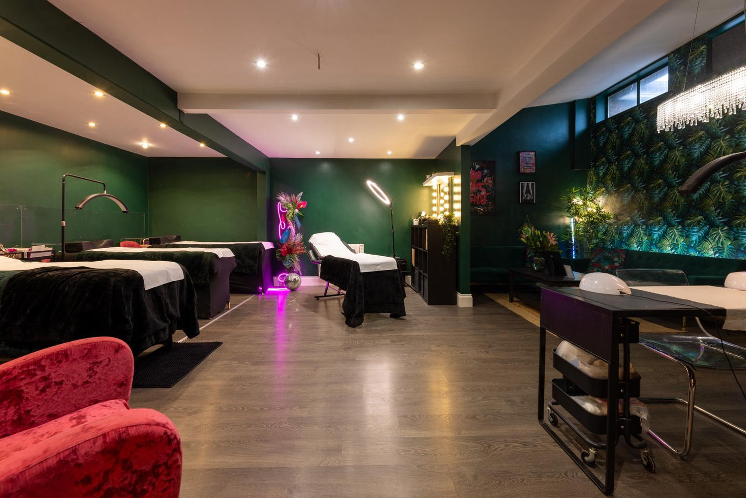 Spa or salon interior with massage tables, chairs, and decorative elements.